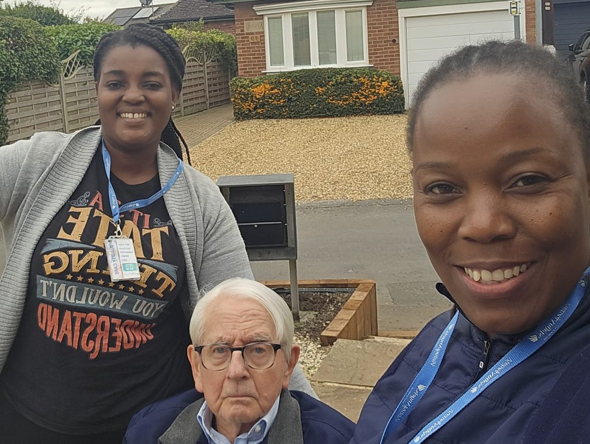 two carers taking a walk with the client