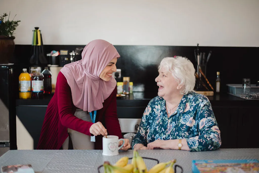 A Visiting Angels carer providing flu season elderly care to an elderly woman at home in Banbury, Oxfordshire — compassionate, professional, CQC rated home care