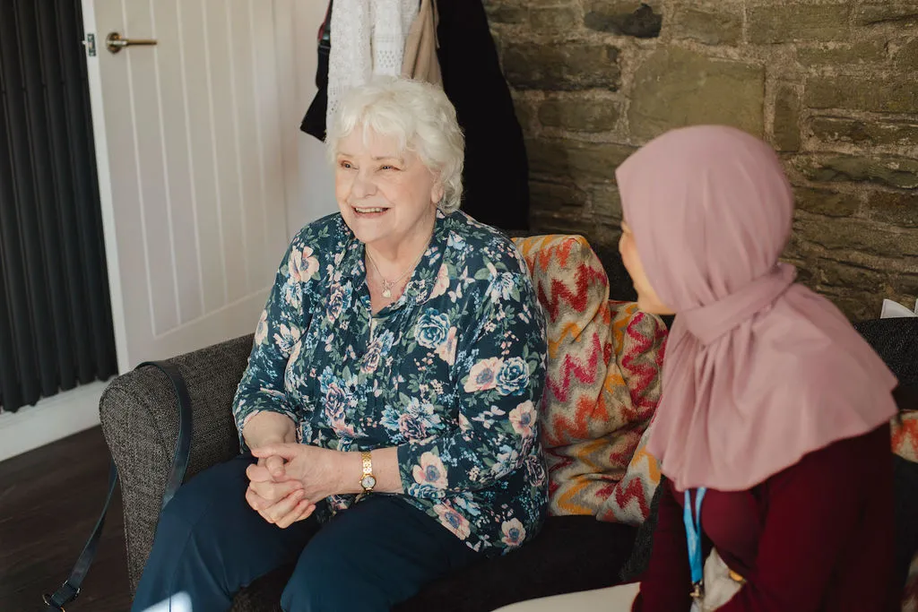 A Visiting Angels carer providing companionship care to an elderly woman at home in Oxford, Oxfordshire — supportive, friendly, CQC Good rated home care