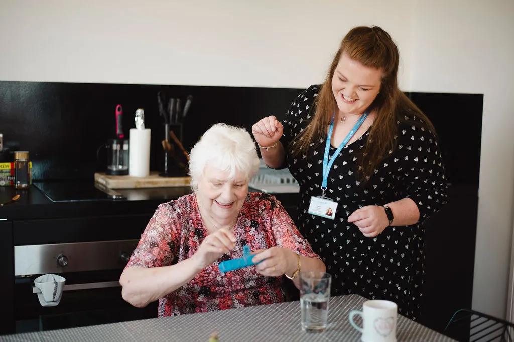 A Visiting Angels carer providing medication errors home care Oxford support to an elderly woman in Headington, Oxfordshire — compassionate, professional, CQC rated home care