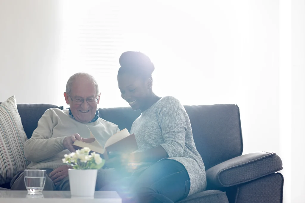 A Visiting Angels carer providing in‑home care and companionship to an elderly couple at home in Abingdon, Oxfordshire — compassionate, professional, CQC rated home care