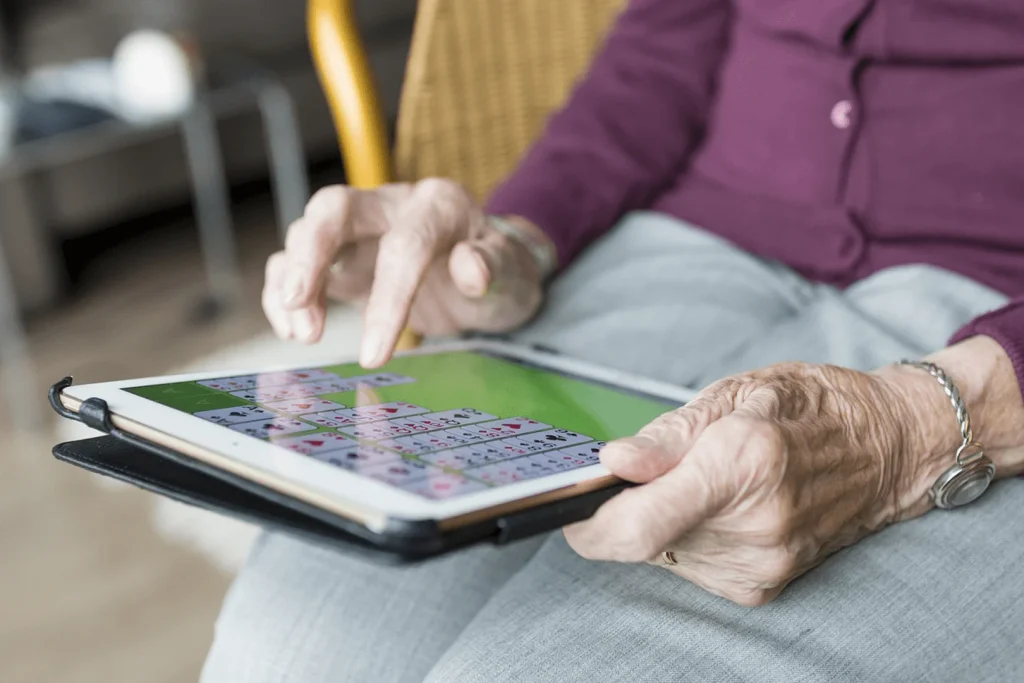 A Visiting Angels carer providing memory games for elderly Oxford to an elderly woman at home in Oxford, Oxfordshire — compassionate, professional, CQC rated home care