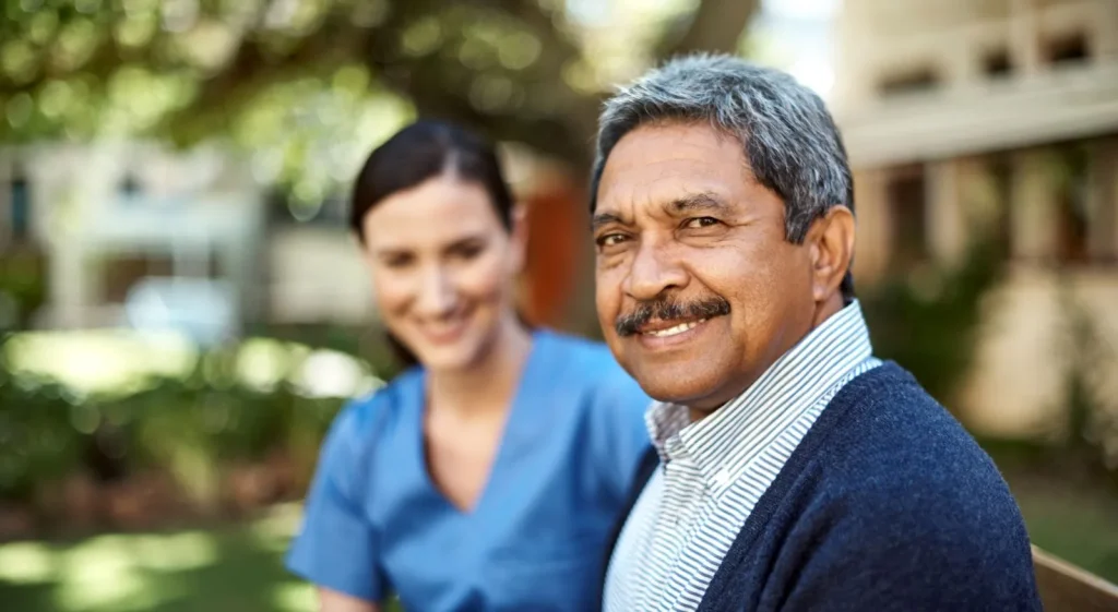 A Visiting Angels carer providing home care guidance to an elderly man in Oxford, Oxfordshire — compassionate, professional, CQC rated home care