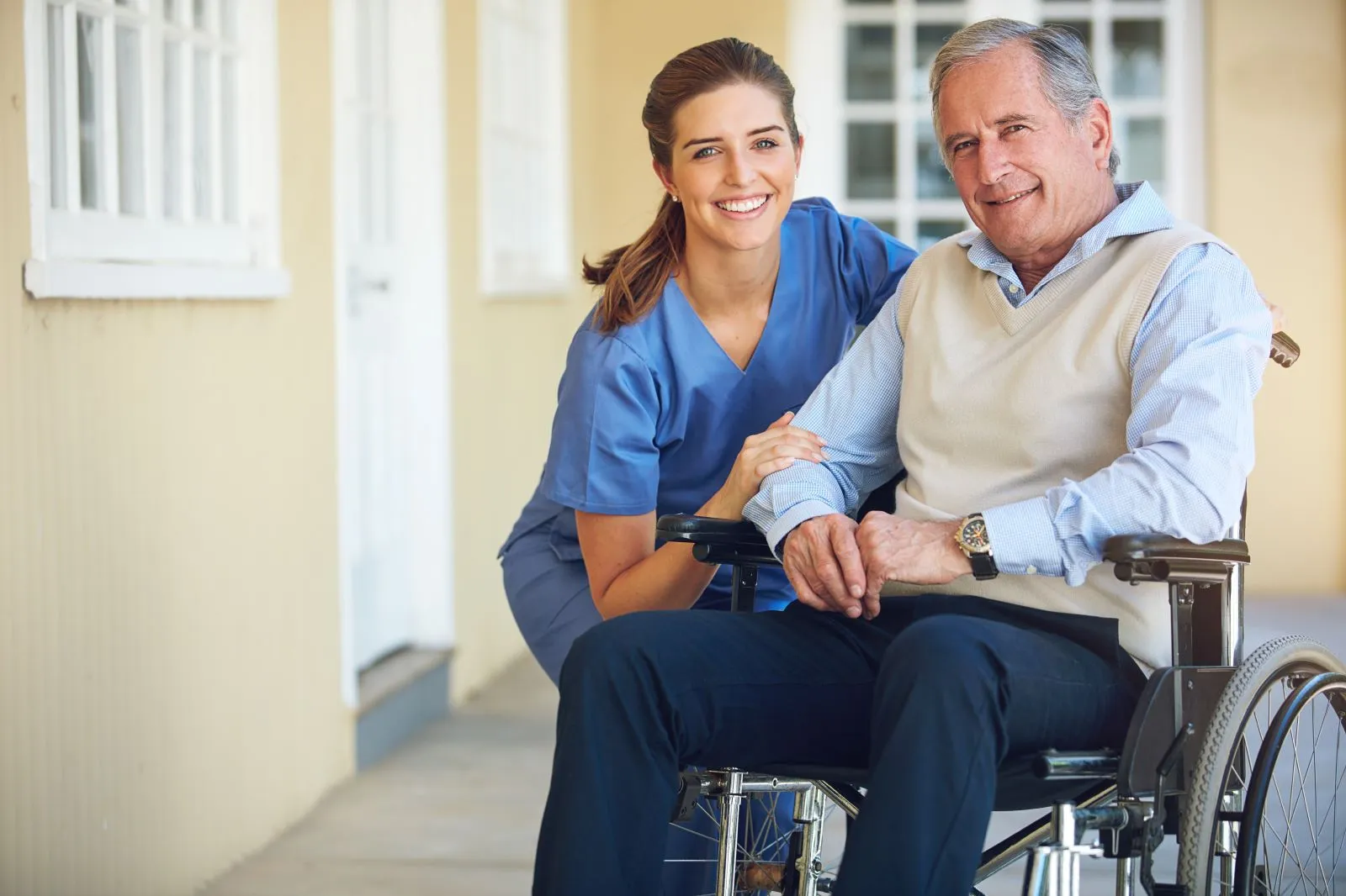 A Visiting Angels carer providing respite care and companionship to an elderly man in a wheelchair at home in Oxford, Oxfordshire — compassionate, professional, CQC rated home care