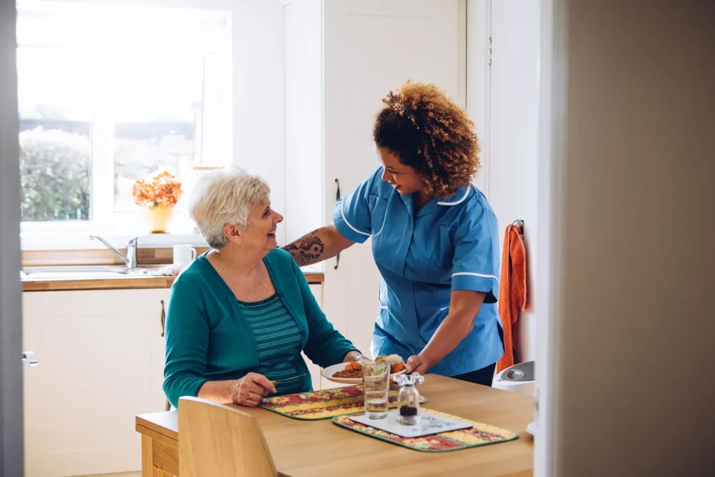 A Visiting Angels carer providing personal care to an elderly woman at home in Headington, Oxfordshire — compassionate, professional, CQC rated home care
