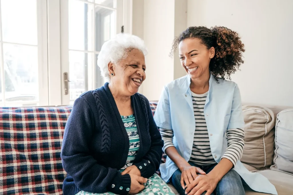 A Visiting Angels carer providing dementia care services to an elderly woman at home in Headington, Oxfordshire — compassionate, professional, CQC Good rated home care