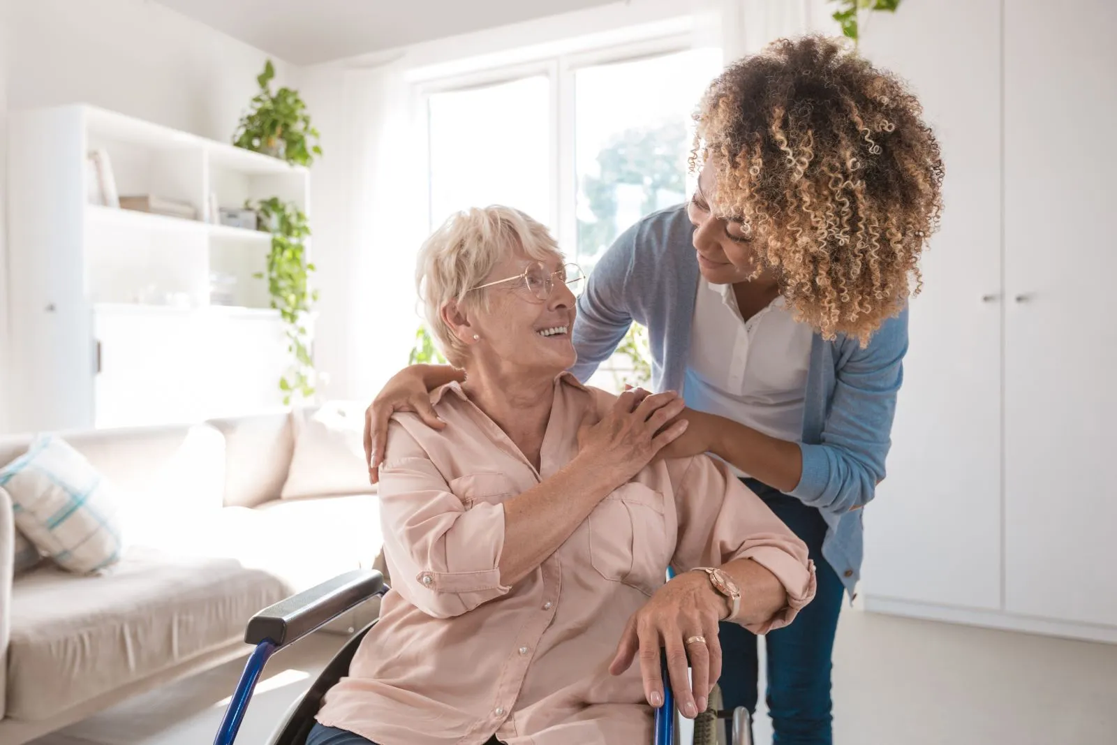 A Visiting Angels carer providing dementia care to an elderly woman in a wheelchair at home in Kidlington, Oxfordshire — compassionate, professional, CQC Good rated home care