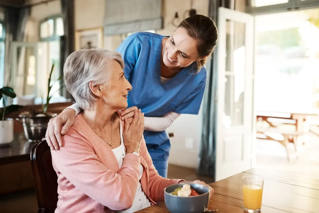 A Visiting Angels carer providing dementia care to an elderly woman at home in Thame, Oxfordshire — compassionate, professional, CQC Good rated home care