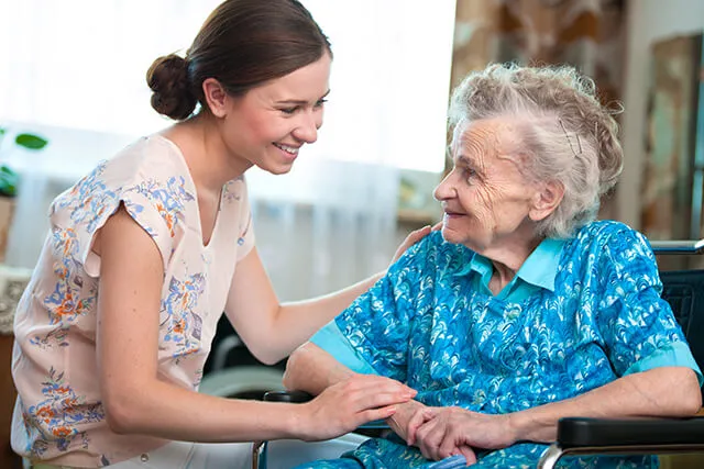 A Visiting Angels carer providing dementia care to an elderly woman at home in Abingdon, Oxfordshire — compassionate, professional, CQC rated home care