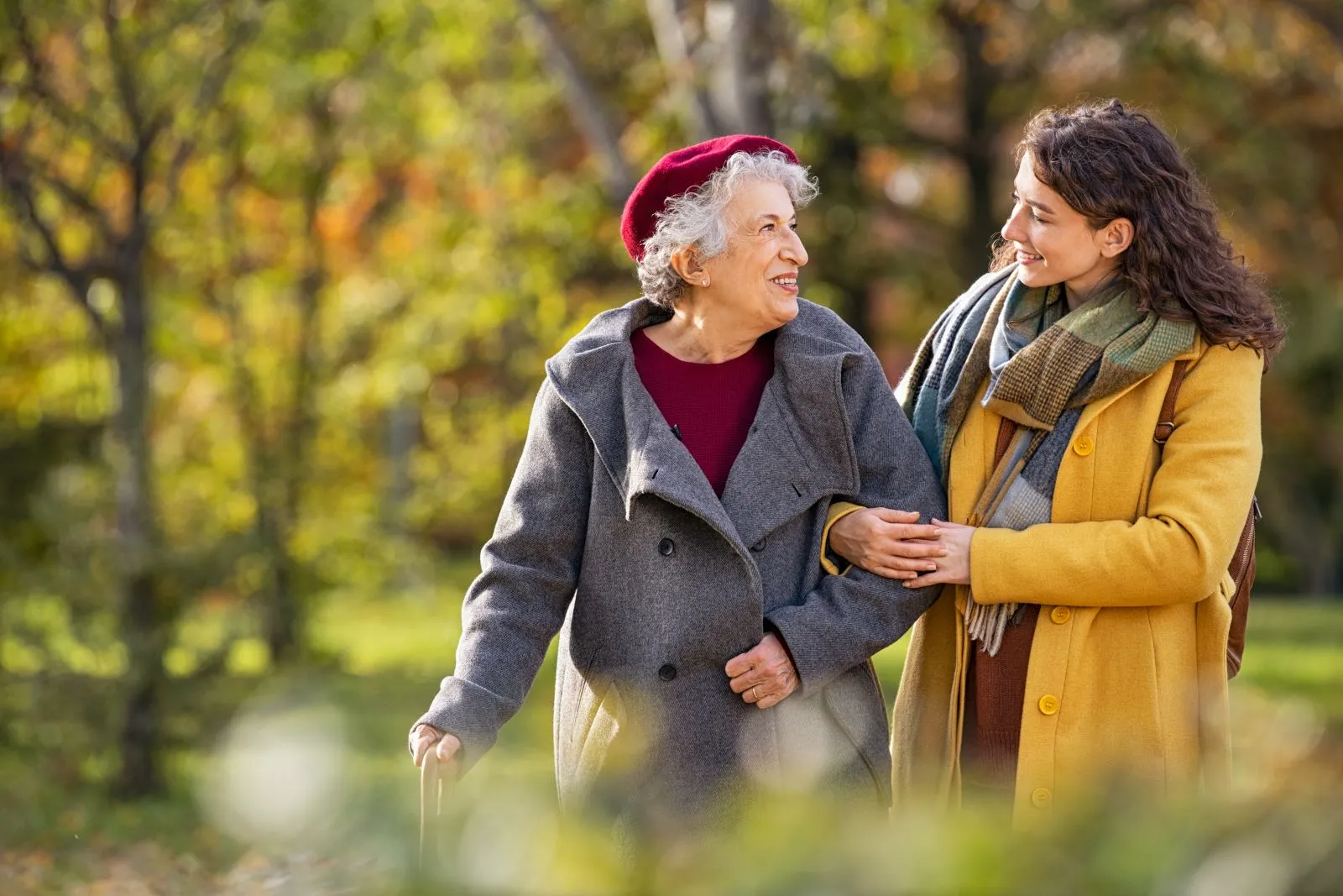 A Visiting Angels carer providing elderly care services to an elderly woman outdoors in Bicester, Oxfordshire — compassionate, professional, CQC Good rated home care