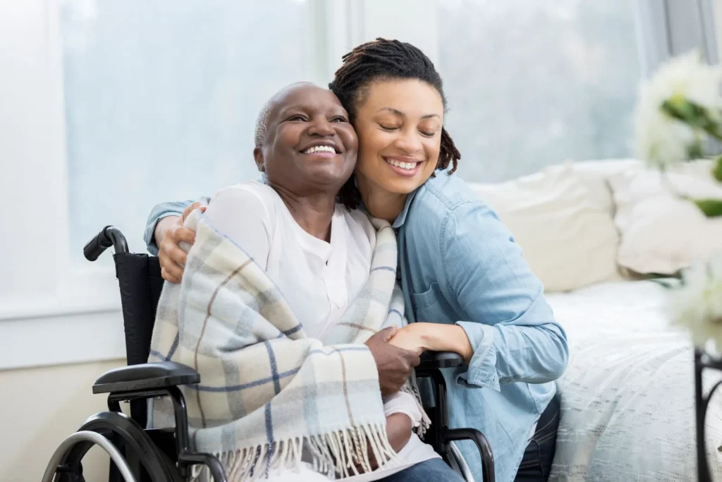 A Visiting Angels carer providing elderly care services to an elderly woman in a wheelchair at home in Kidlington, Oxfordshire — compassionate, professional, CQC Good rated care