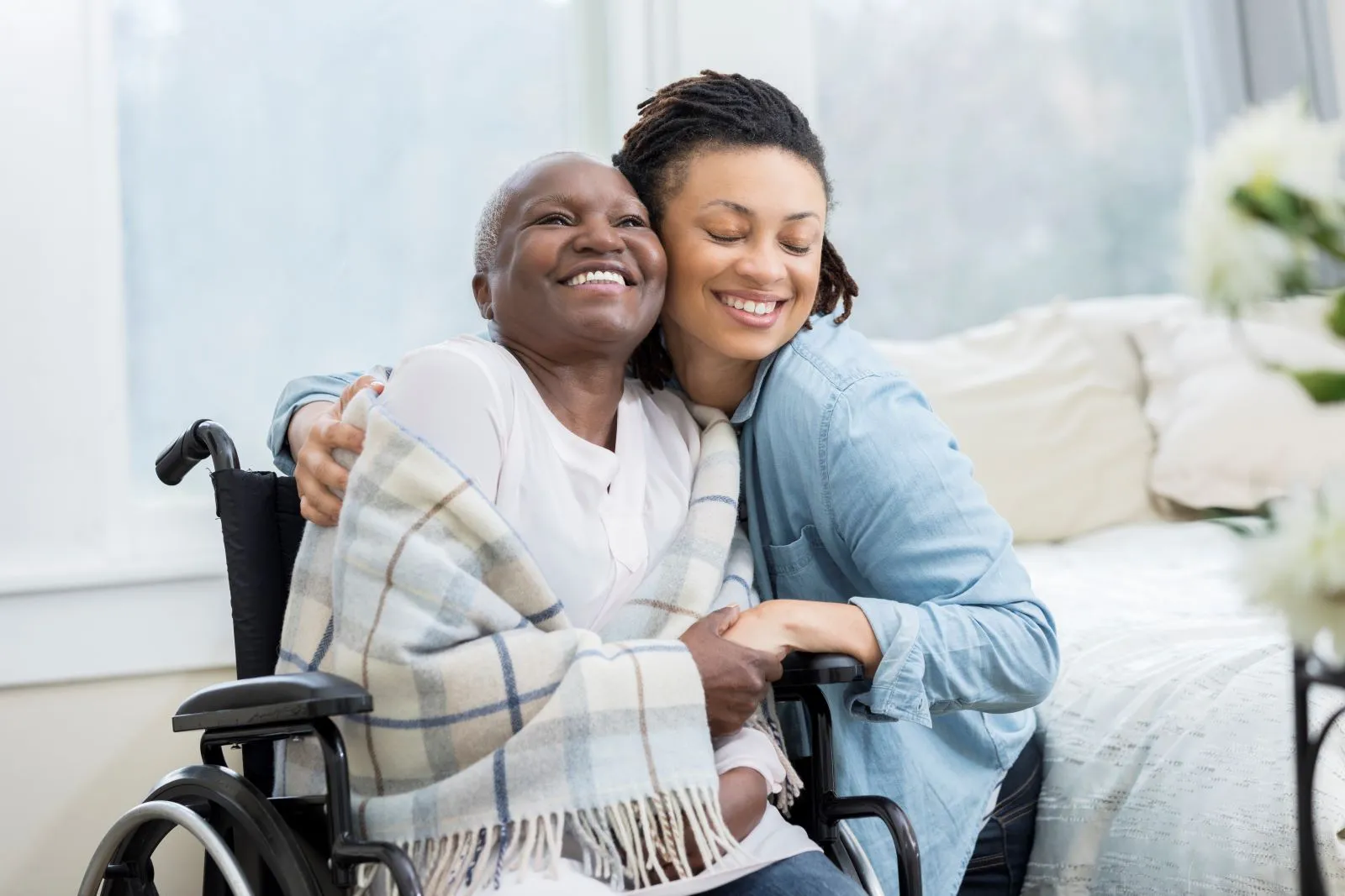 A Visiting Angels carer providing elderly care services to an elderly woman in a wheelchair at home in Kidlington, Oxfordshire — compassionate, professional, CQC Good rated care