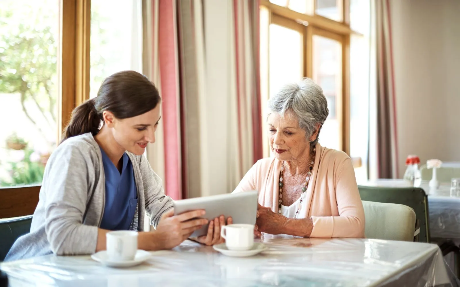 A Visiting Angels carer providing home care agency support to an elderly woman at home in Wheatley, Oxfordshire — compassionate, professional, CQC Good rated home care