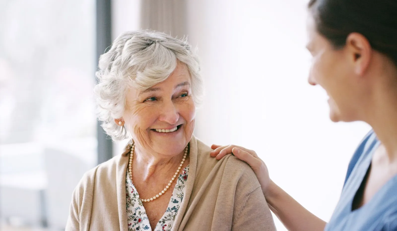 A Visiting Angels carer providing live‑in care services to an elderly woman at home in Banbury, Oxfordshire — compassionate, professional, CQC Good rated home care