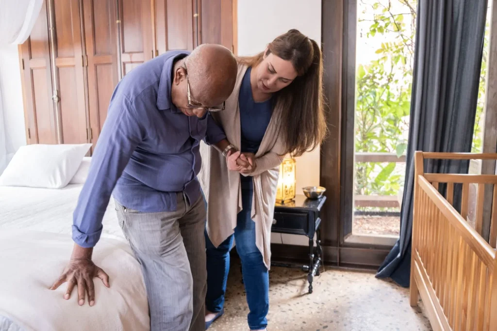 A Visiting Angels carer providing live in care to an elderly man at home in Bicester, Oxfordshire — compassionate, professional, CQC rated home care