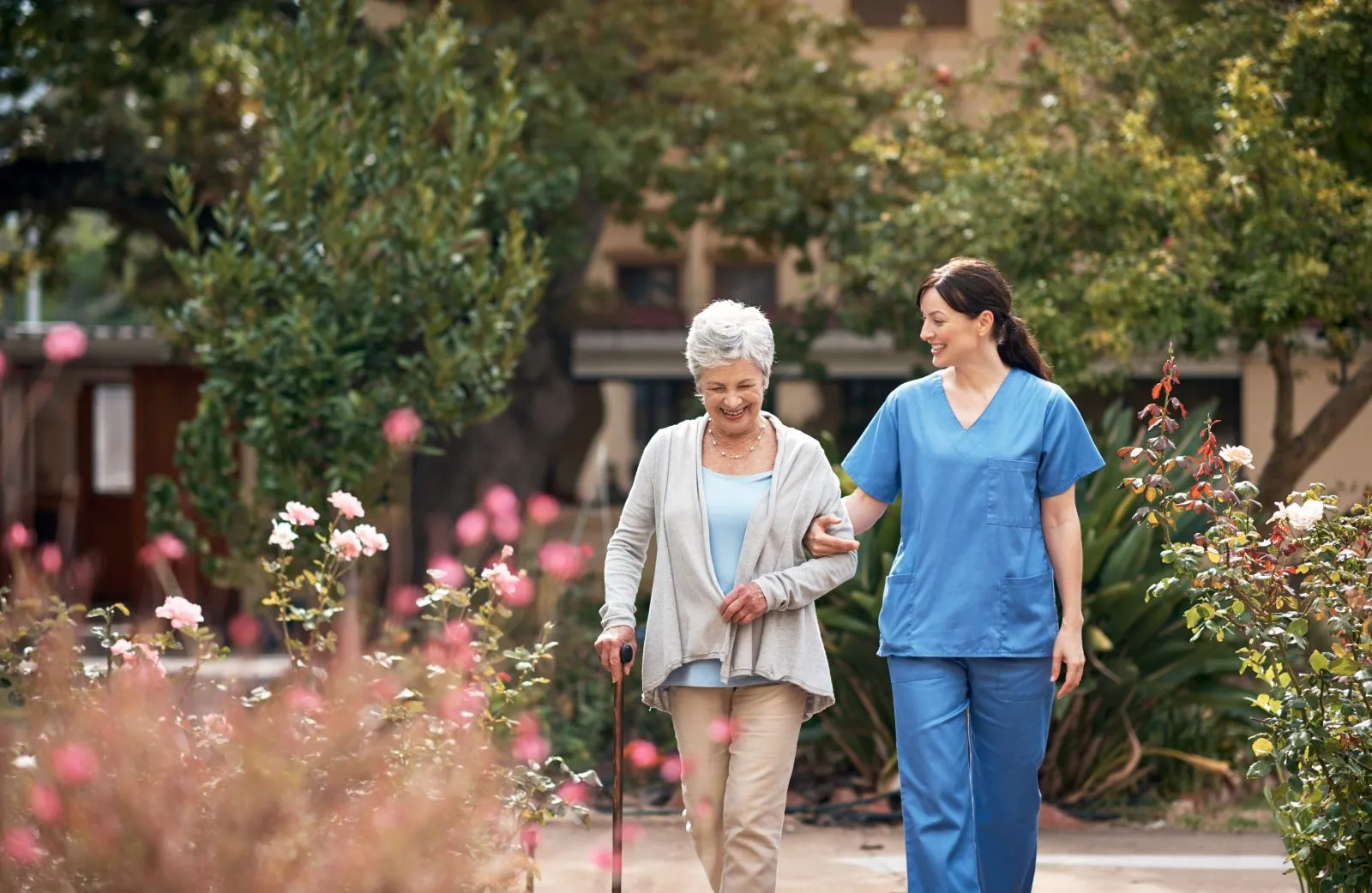 A Visiting Angels carer providing live‑in care services to an elderly woman in a garden in Thame, Oxfordshire — compassionate, professional, CQC Good rated home care
