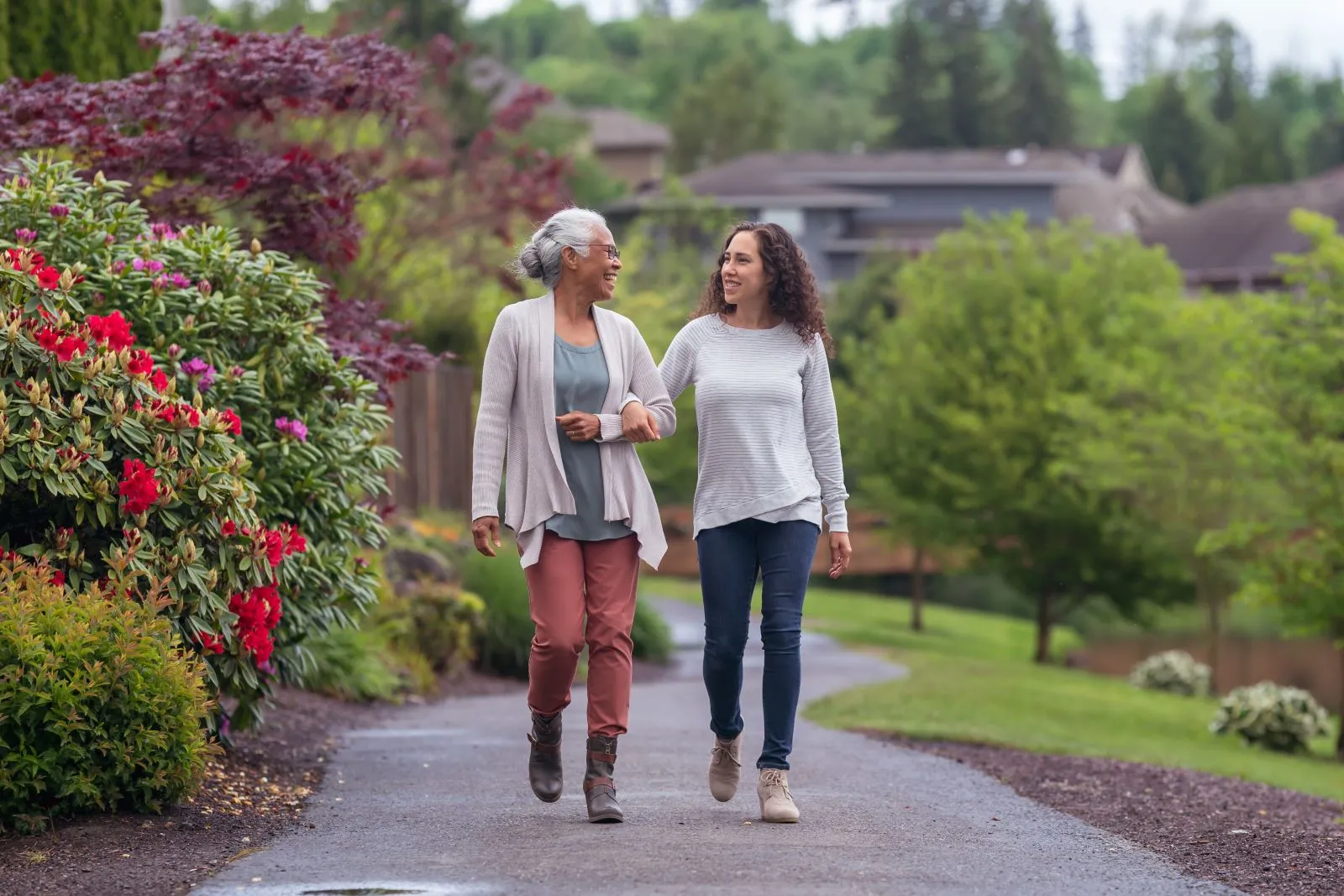 A Visiting Angels carer providing live‑in care services to an elderly woman outdoors in Witney, Oxfordshire — compassionate, professional, CQC Good rated home care