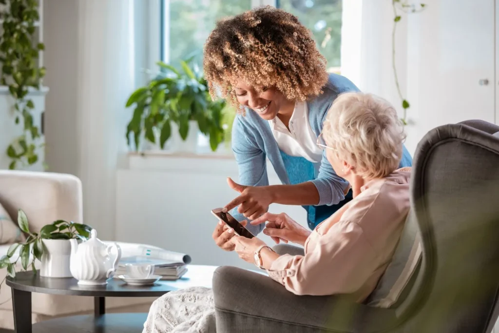 A Visiting Angels carer providing memory‑boosting games to an elderly woman at home in Oxford, Oxfordshire — compassionate, professional, CQC rated home care