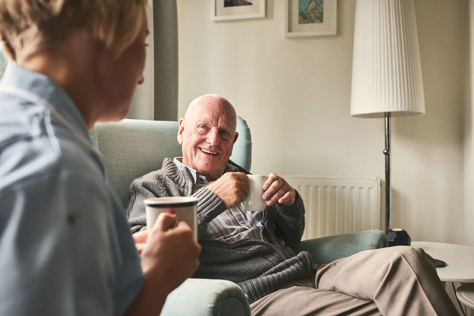 A Visiting Angels carer providing personal care to an elderly man at home in Wheatley, Oxfordshire — compassionate, professional, CQC Good rated home care