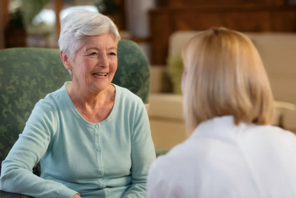A Visiting Angels carer providing technology‑enabled home care support to an elderly woman at home in Oxford, Oxfordshire — compassionate, professional, CQC rated home care