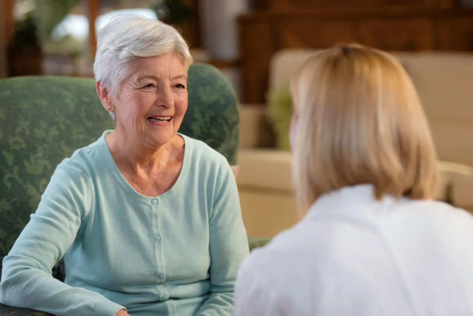 A Visiting Angels carer providing technology‑enabled home care support to an elderly woman at home in Oxford, Oxfordshire — compassionate, professional, CQC rated home care