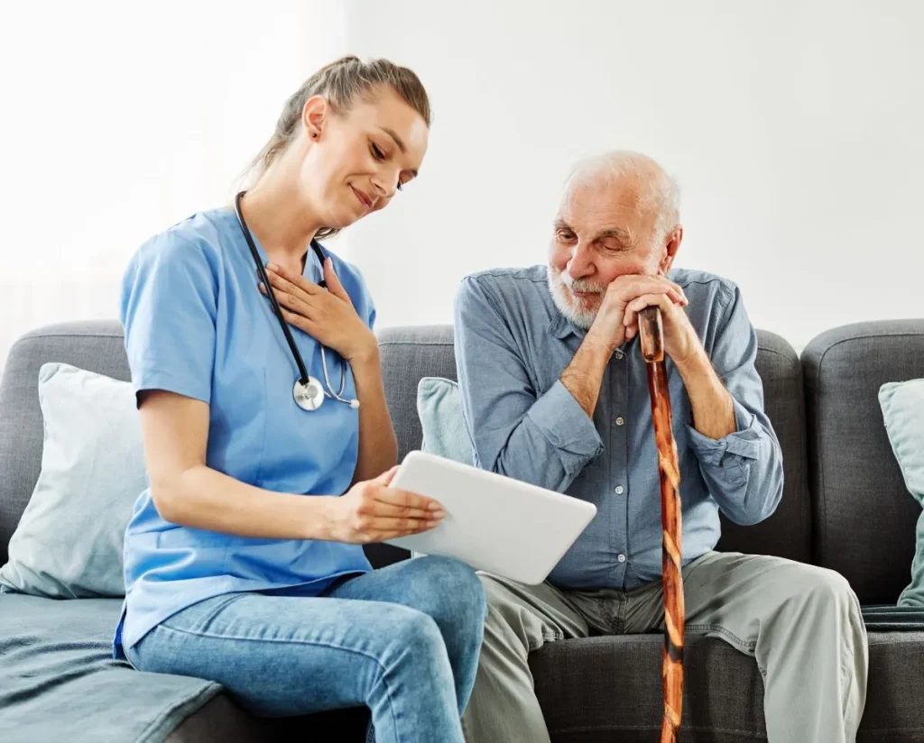 A Visiting Angels carer providing home care to an elderly man at home in Oxford, Oxfordshire — compassionate, professional, CQC rated home care