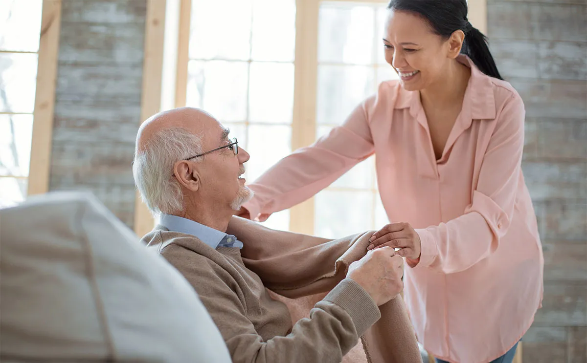 A Visiting Angels carer providing live in care to an elderly man at home in Oxfordshire — compassionate, professional, CQC rated home care