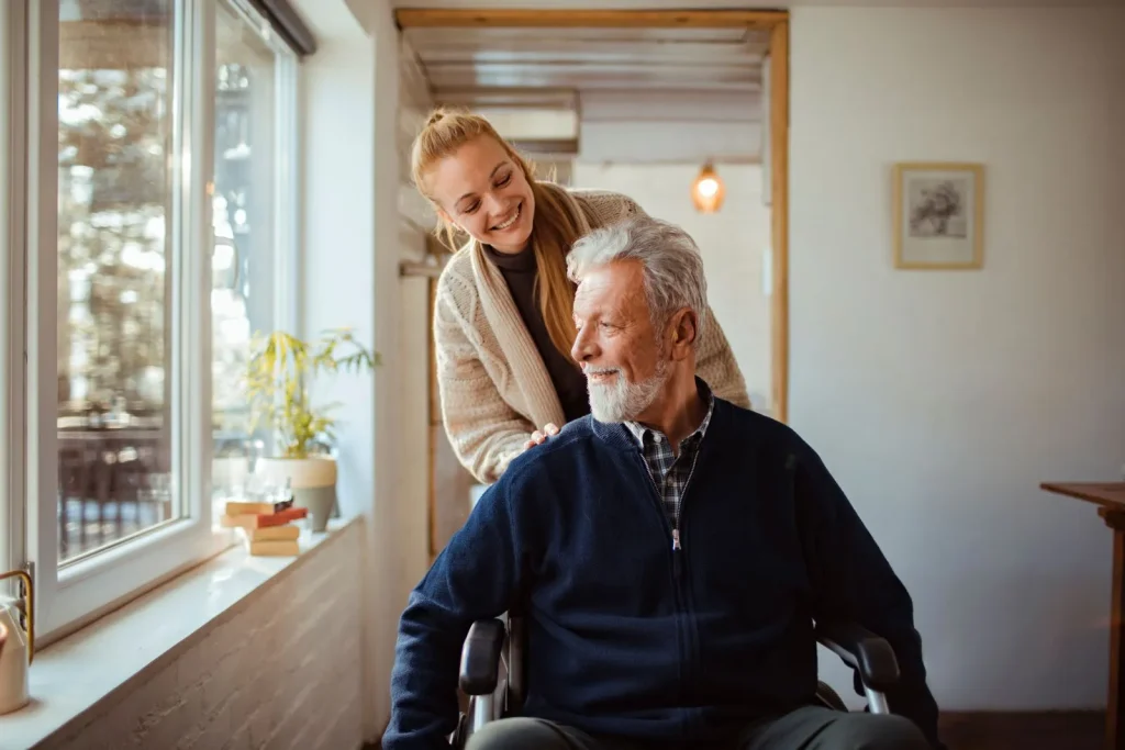 A Visiting Angels carer providing wheelchair support and independent living care to an elderly man in Abingdon, Oxfordshire — compassionate, professional, CQC rated home care