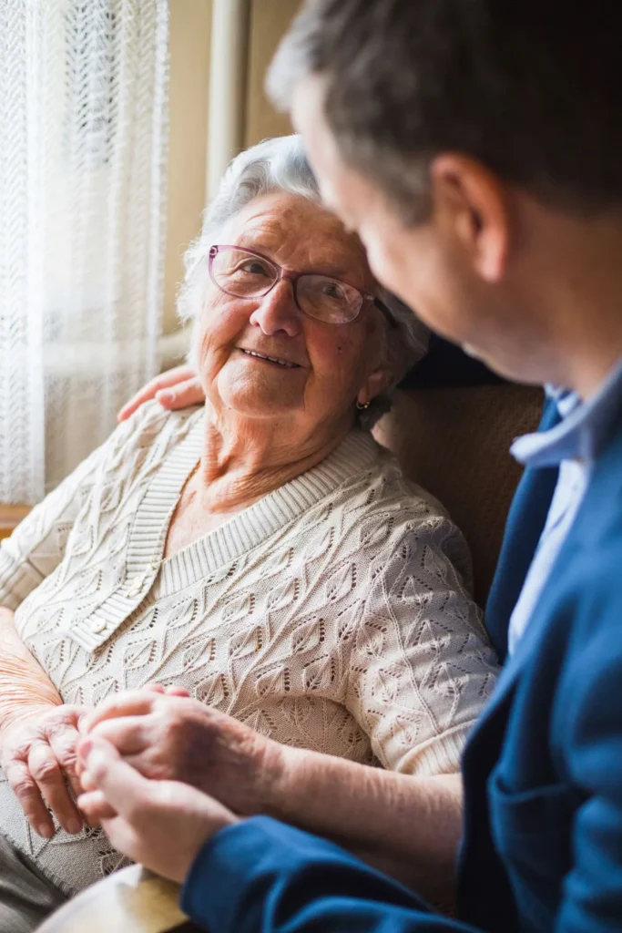A Visiting Angels carer providing family assistance and daily living support to an elderly woman at home in Witney, Oxfordshire — compassionate, professional, CQC rated home care