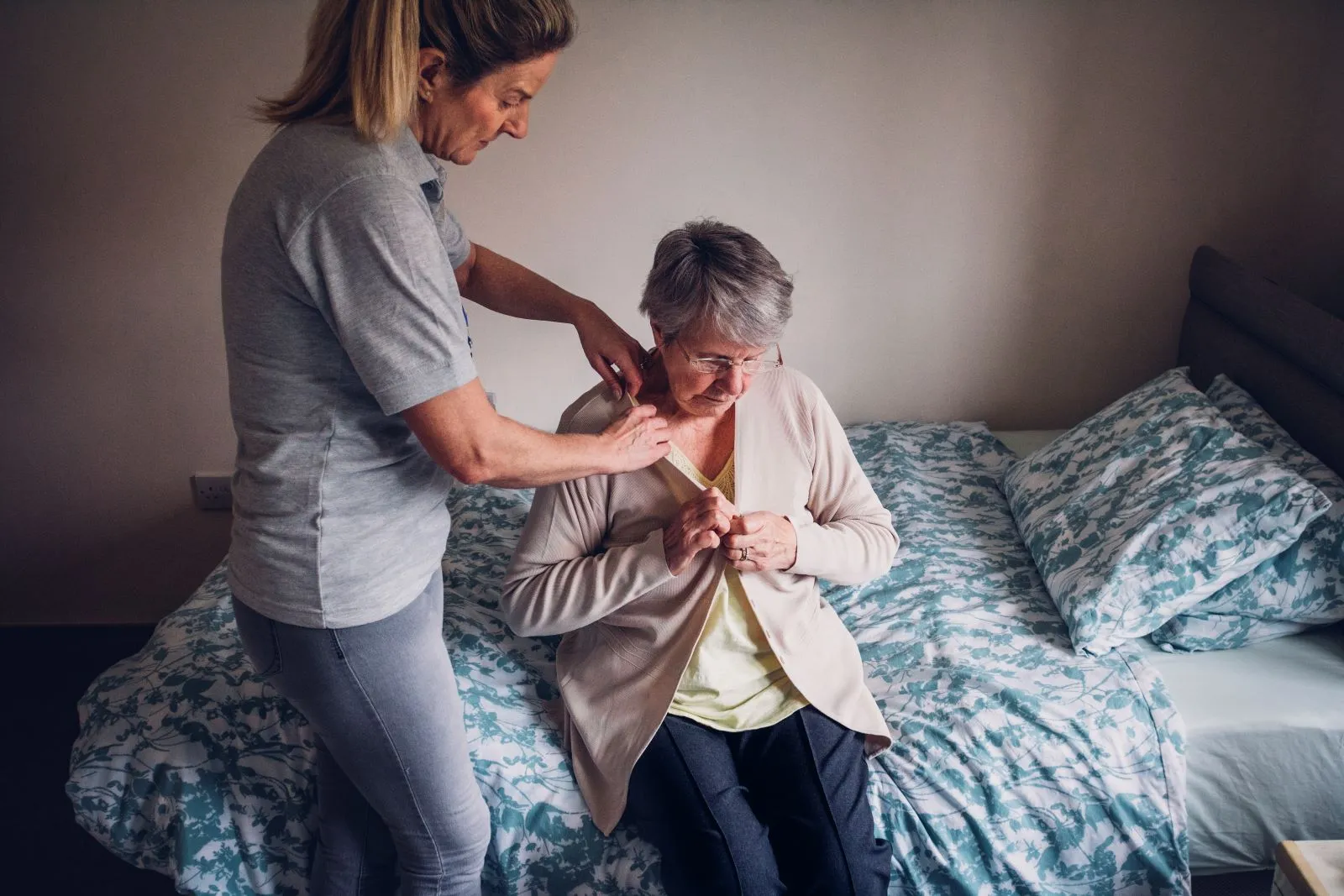 A Visiting Angels carer providing personal care and daily support to an elderly woman at home in Bicester, Oxfordshire — compassionate, professional, CQC rated home care
