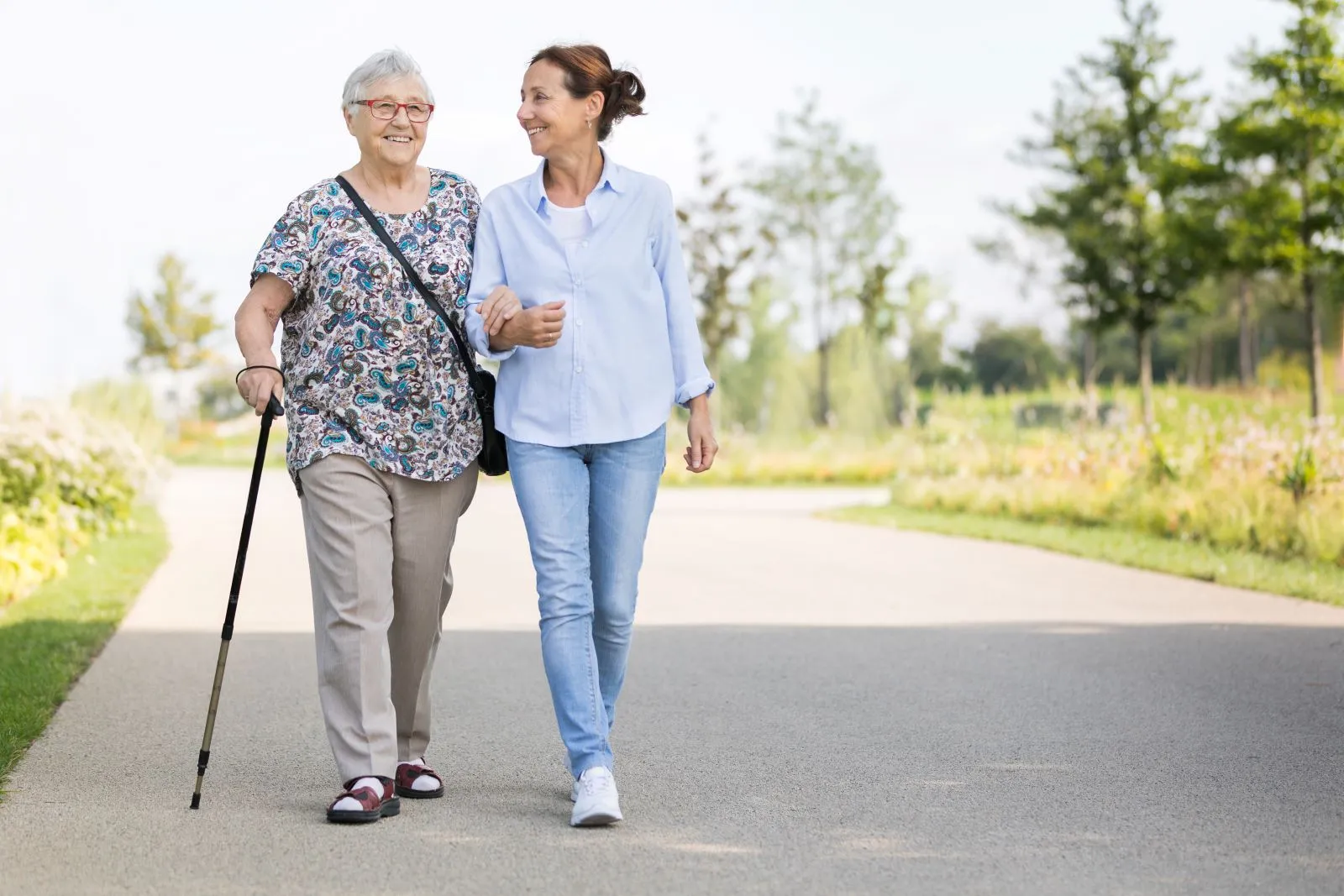 A Visiting Angels carer providing mobility and companionship care to an elderly woman in Bicester, Oxfordshire — compassionate, professional, CQC rated home care