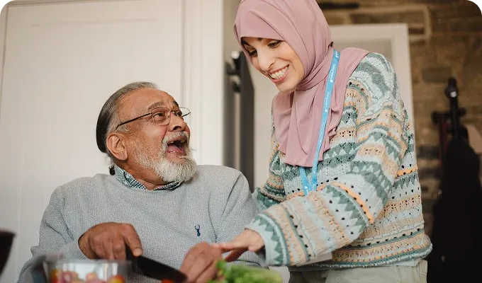 A Visiting Angels carer providing personal care to an elderly man at home in Headington, Oxfordshire — compassionate, professional, CQC rated home care