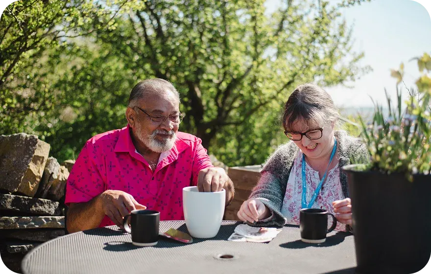 A Visiting Angels carer providing respite care to elderly people outdoors in Witney, Oxfordshire — compassionate, professional, CQC rated home care