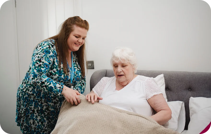 A Visiting Angels carer providing overnight care to an elderly woman in Abingdon, Oxfordshire — compassionate, professional, CQC rated home care