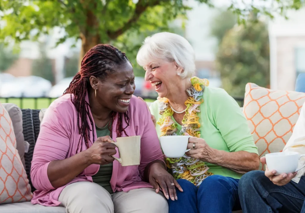 A Visiting Angels carer providing respite care to elderly women in Woodstock, Oxfordshire — compassionate, professional, CQC rated home care