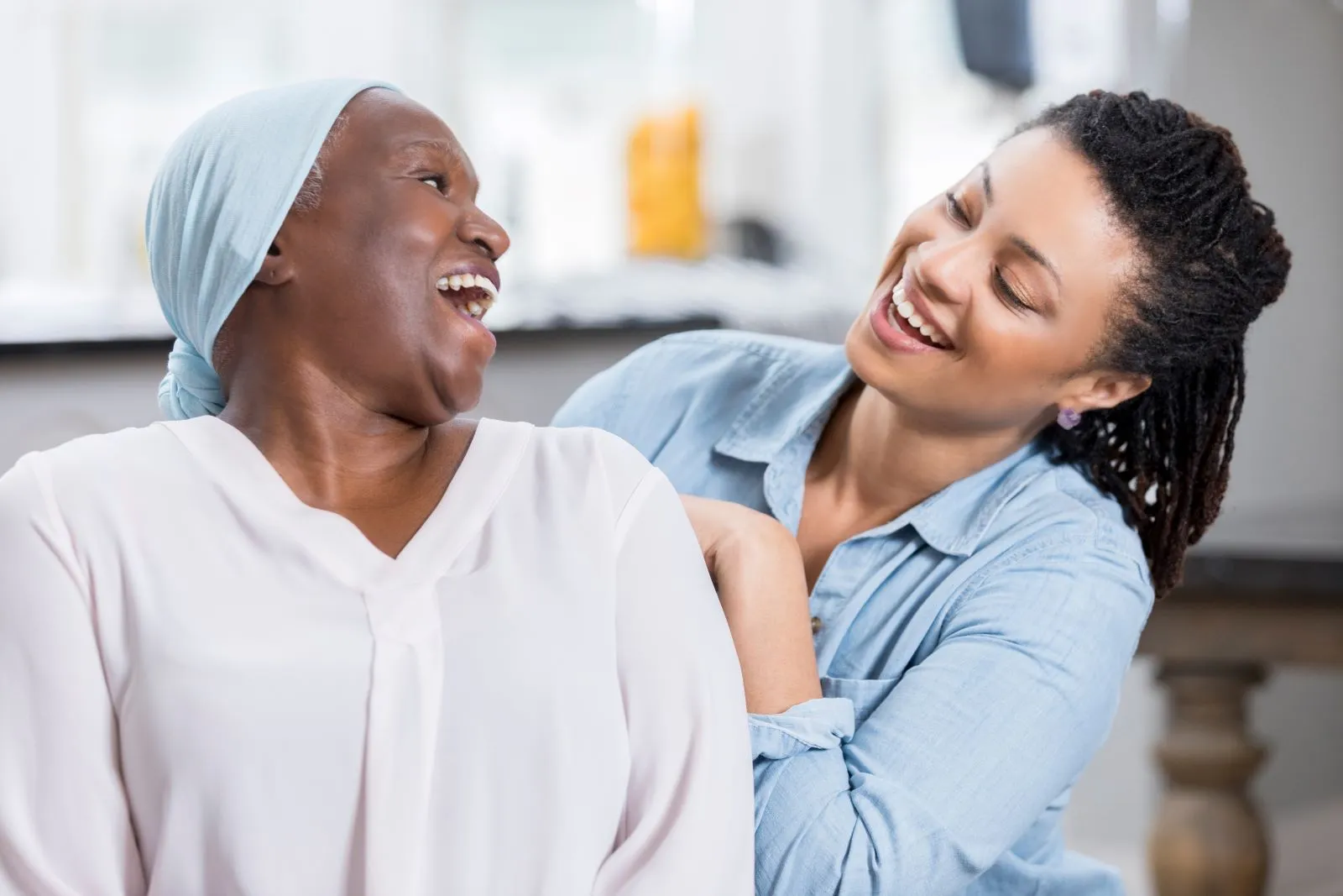 A Visiting Angels carer providing companionship and emotional care to an elderly woman at home in Thame, Oxfordshire — compassionate, professional, CQC rated home care