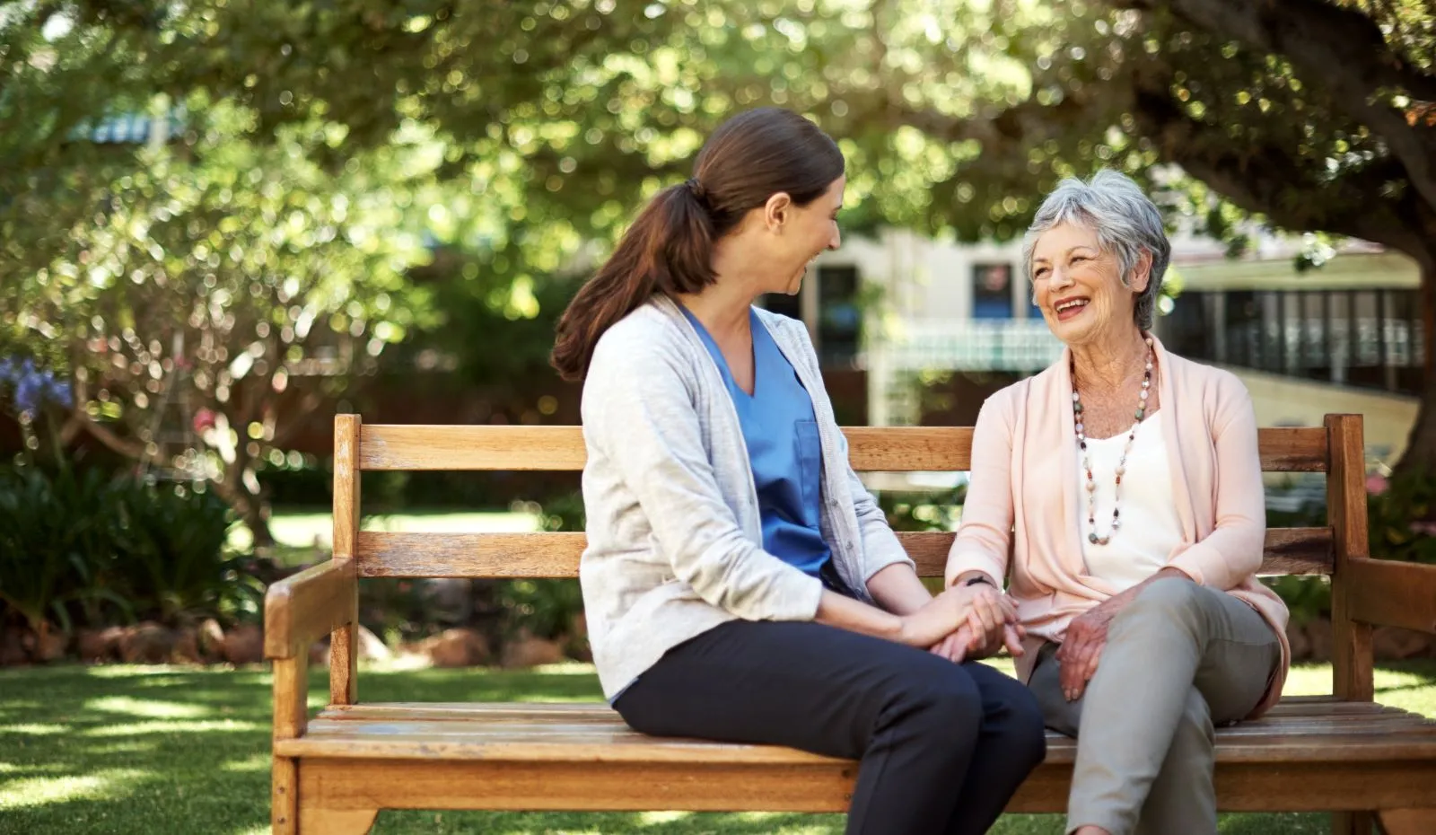 A Visiting Angels carer providing companionship and outdoor support to an elderly woman in Wheatley, Oxfordshire — compassionate, professional, CQC rated home care