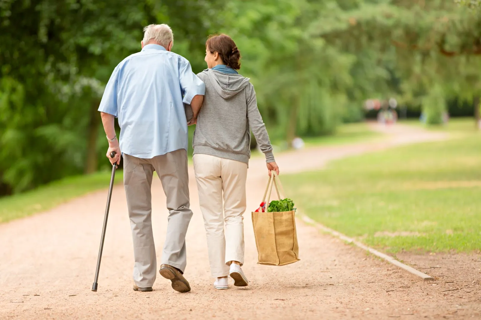 A Visiting Angels carer providing mobility and errand support to an elderly man in Wheatley, Oxfordshire — compassionate, professional, CQC rated home care