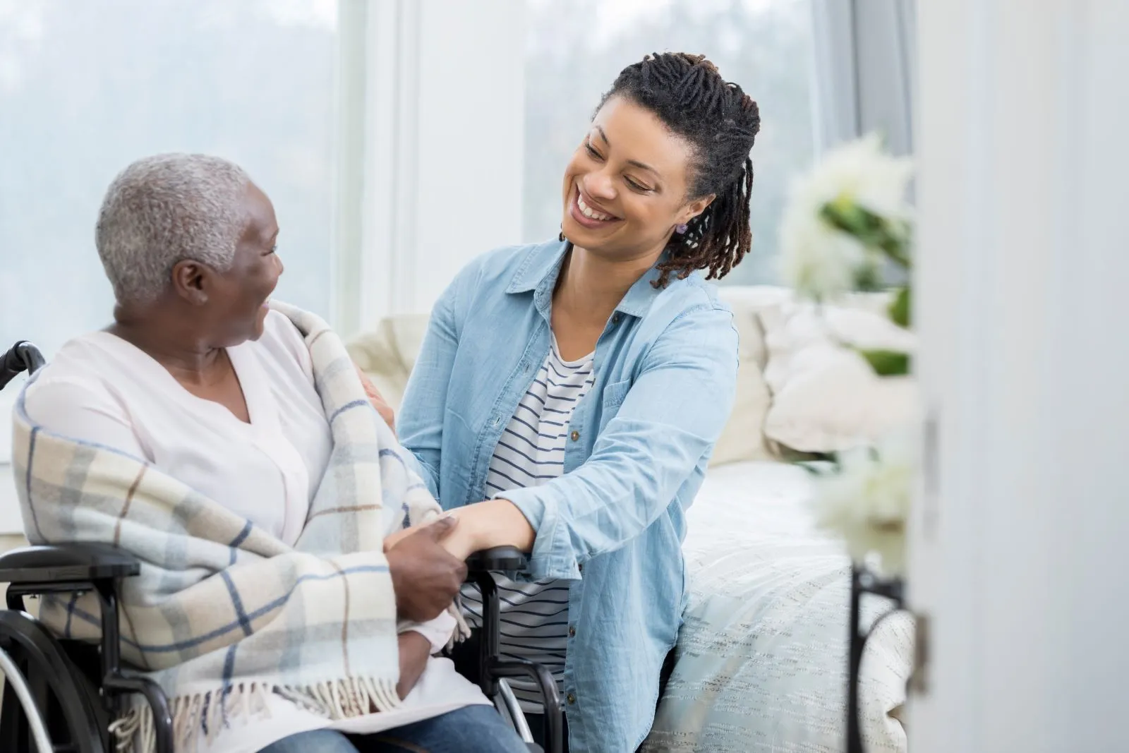 A Visiting Angels carer providing wheelchair support and compassionate care to an elderly woman in Wheatley, Oxfordshire — professional, CQC rated home care