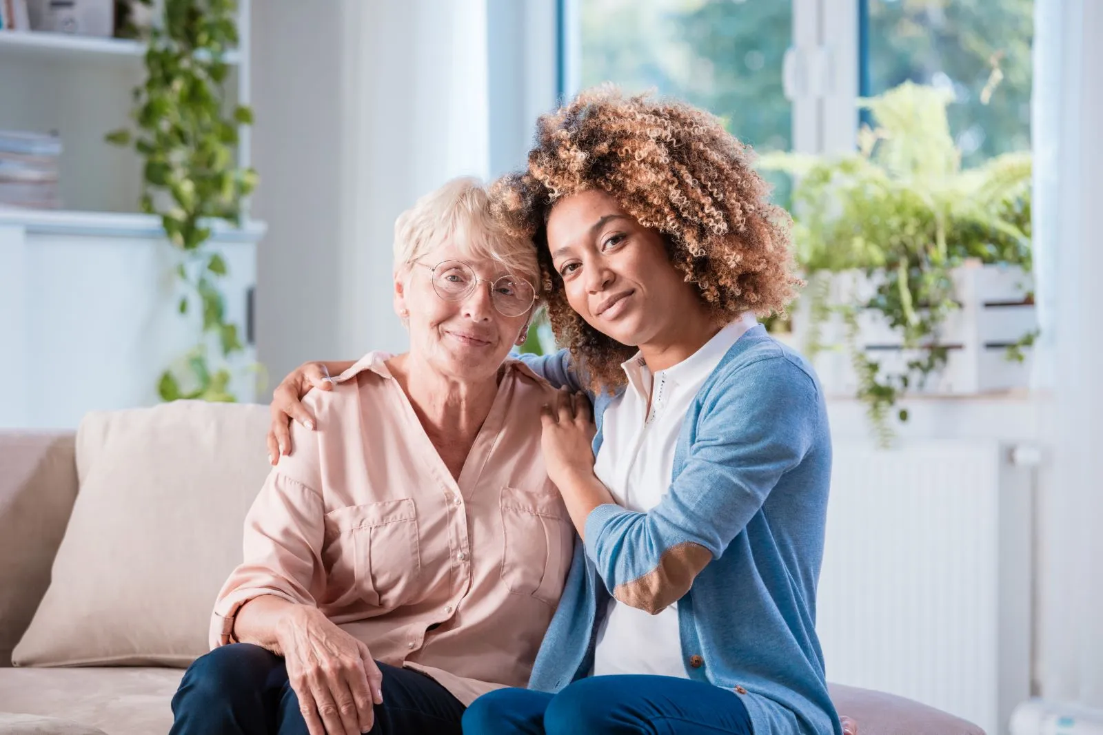 A Visiting Angels carer providing companionship and emotional support to an elderly woman at home in Woodstock, Oxfordshire — compassionate, professional, CQC rated home care