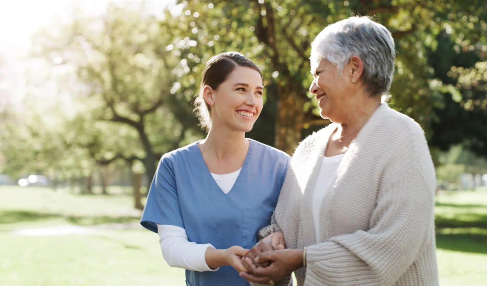 A Visiting Angels carer providing personal care and outdoor support to an elderly woman in Woodstock, Oxfordshire — compassionate, professional, CQC rated home care