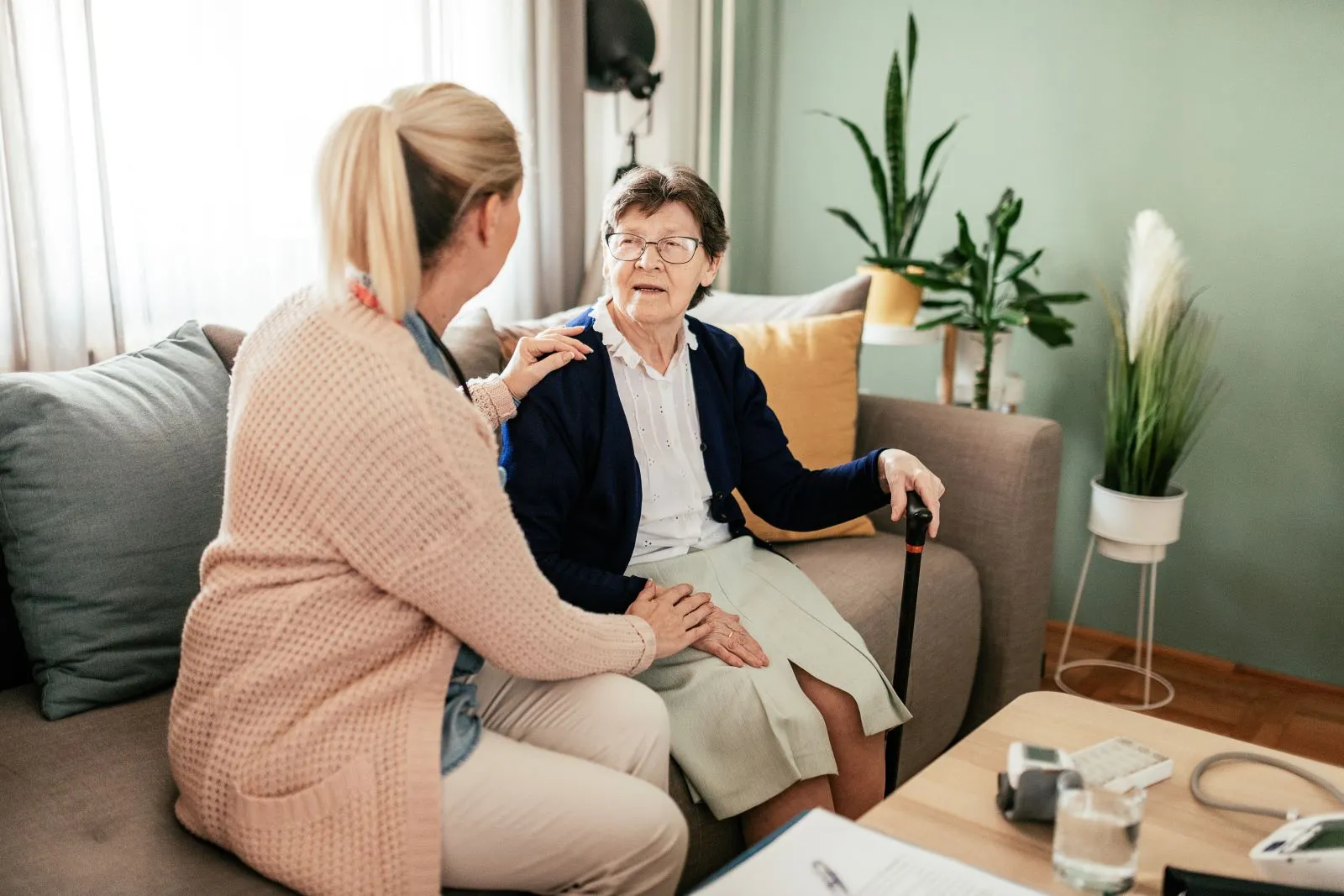 A Visiting Angels carer providing compassionate home care to an elderly woman in Woodstock, Oxfordshire — professional, CQC rated home care