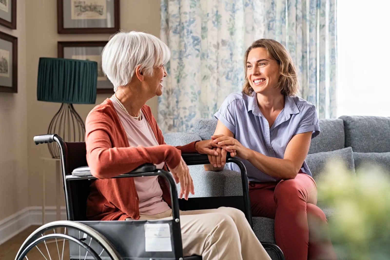 A Visiting Angels carer providing healthcare support to an elderly woman in a wheelchair at home in Oxford, Oxfordshire — compassionate, professional, CQC rated home care