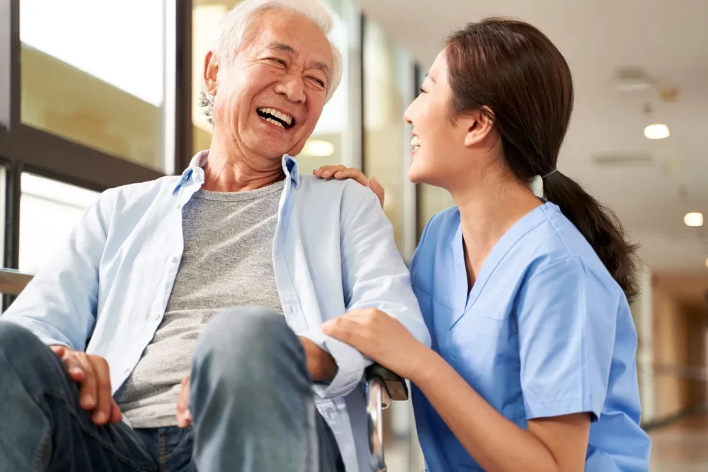 A Visiting Angels carer providing Parkinson’s care to an elderly man at home in Summertown, Oxfordshire — compassionate, professional, CQC rated home care