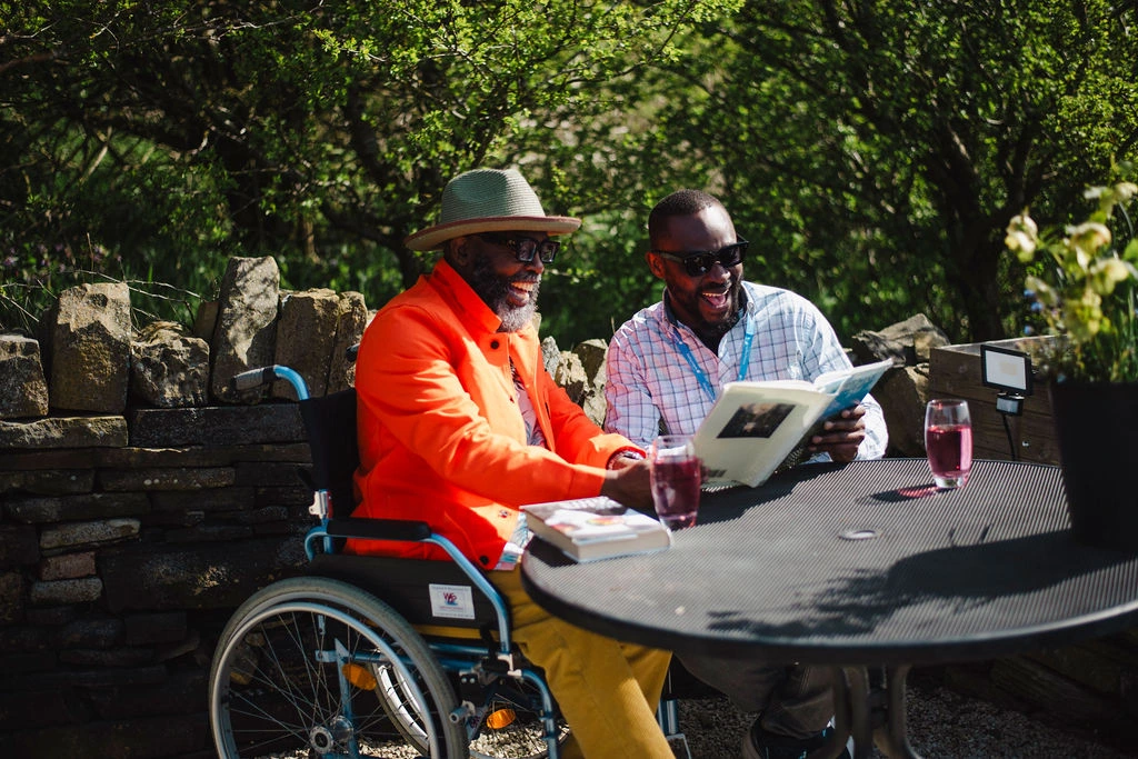 Oxford care agency carer enjoying a sunny afternoon outdoors with elderly wheelchair user client – Visiting Angels
